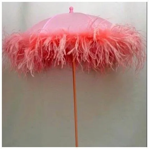 Close-up of a pink feather-trimmed patio umbrella